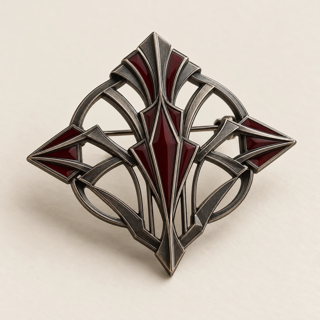 Nocturne Emblem Brooch, gunmetal / burgundy, geometric openwork design